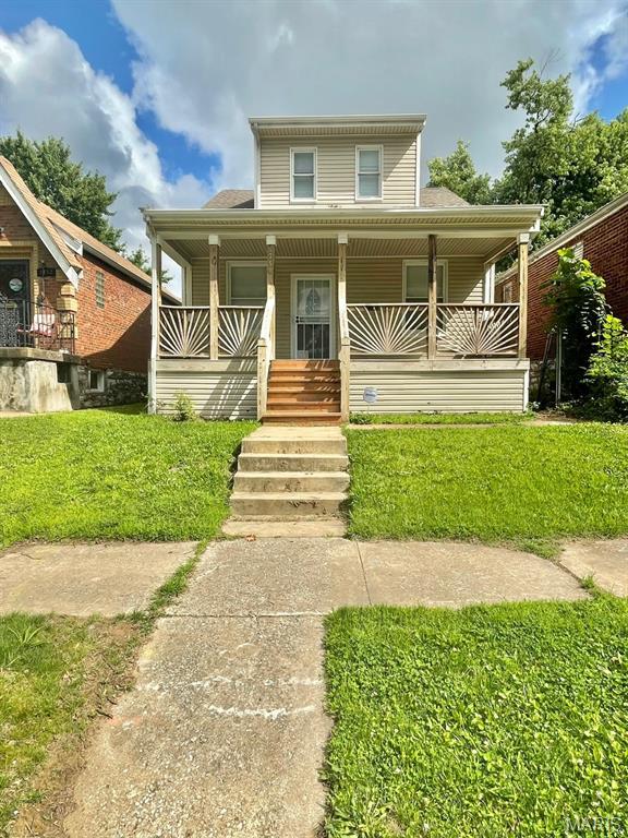 5350 Claxton Ave, Saint Louis, MO 63120 - view of front of home featuring covered porch, a front yard, and a shingled roof