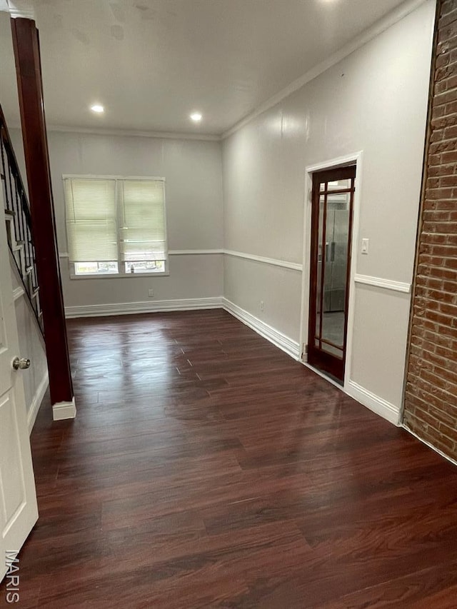 5350 Claxton Ave, Saint Louis, MO 63120 - spare room with ornamental molding, dark wood-style floors, stairs, and recessed lighting