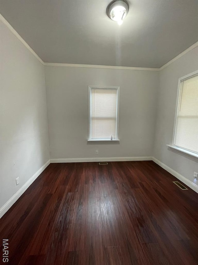 5350 Claxton Ave, Saint Louis, MO 63120 - spare room featuring crown molding, wood finished floors, and healthy amount of natural light