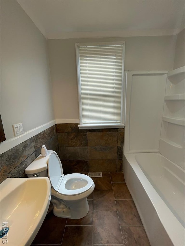5350 Claxton Ave, Saint Louis, MO 63120 - full bathroom with a wainscoted wall and tile walls