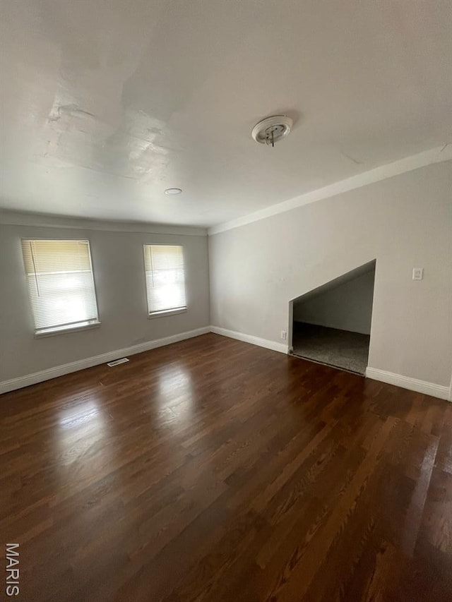 5350 Claxton Ave, Saint Louis, MO 63120 - unfurnished living room featuring dark wood-style floors and ornamental molding
