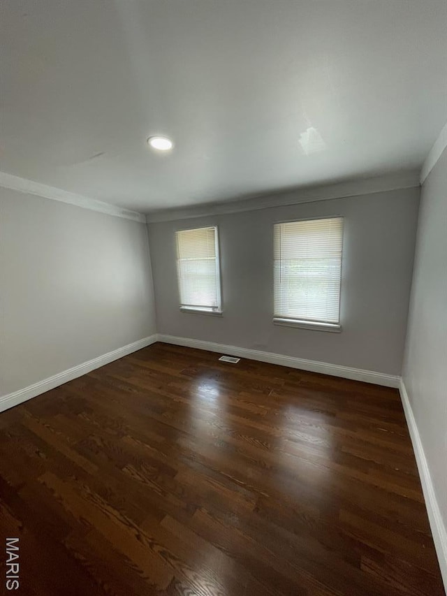 5350 Claxton Ave, Saint Louis, MO 63120 - spare room with ornamental molding, healthy amount of natural light, dark wood finished floors, and recessed lighting