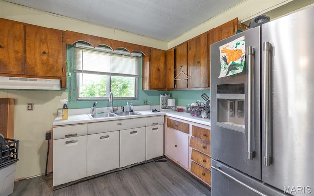 21535 State Route K, Beulah, MO 65436 - kitchen featuring stainless steel refrigerator with ice dispenser, light countertops, under cabinet range hood, dark wood finished floors, and a textured ceiling