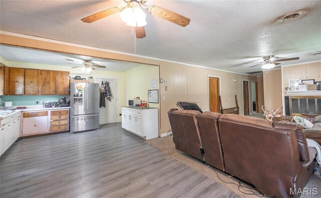 21535 State Route K, Beulah, MO 65436 - living room featuring ceiling fan, a textured ceiling, wood finished floors, and ornamental molding