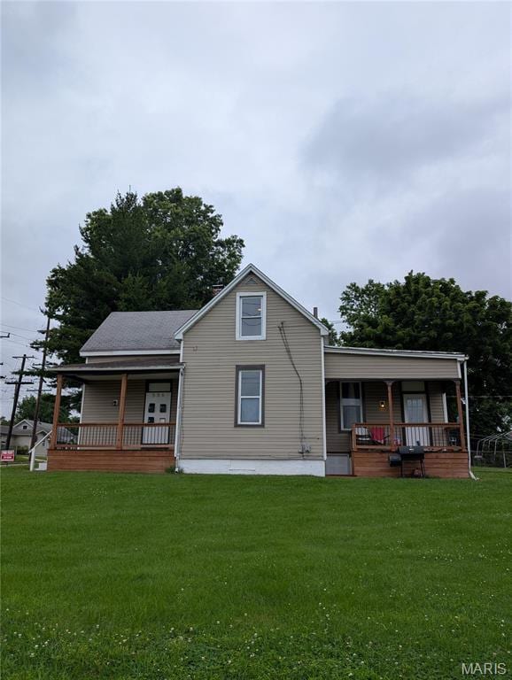 506 N 17th St, Belleville, IL 62226 - rear view of house featuring a porch and a yard