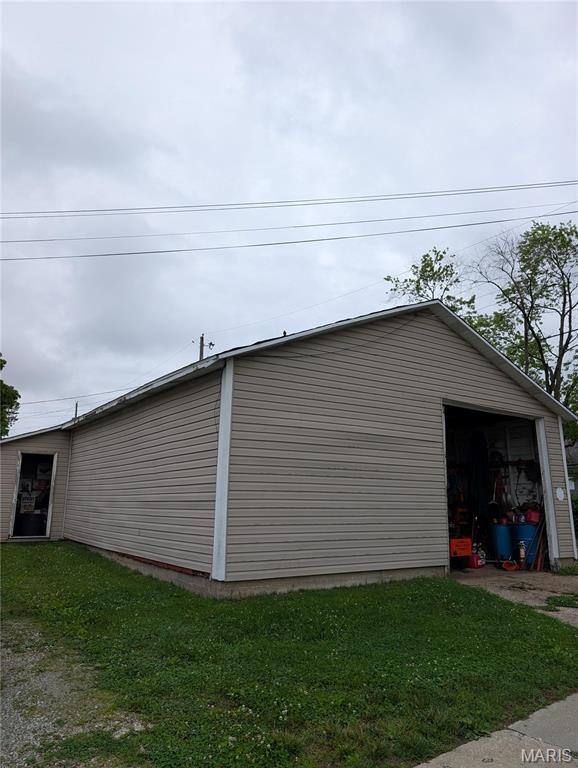 506 N 17th St, Belleville, IL 62226 - view of home's exterior with a garage, an outdoor structure, and a lawn