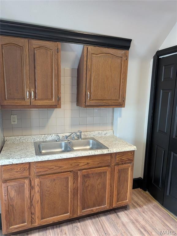 506 N 17th St, Belleville, IL 62226 - kitchen featuring tasteful backsplash, light wood finished floors, and brown cabinets