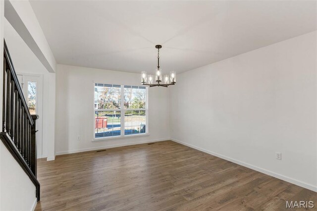 807 Colony Ridge Ct, Foristell, MO 63348 - empty room featuring a chandelier, plenty of natural light, wood finished floors, and stairway