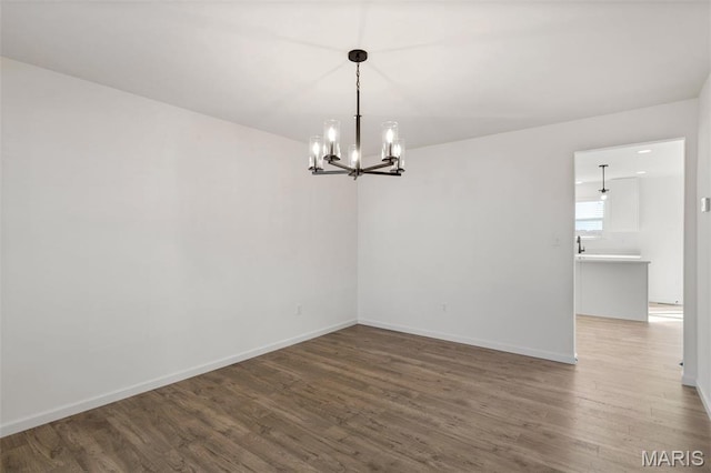 807 Colony Ridge Ct, Foristell, MO 63348 - spare room featuring wood finished floors and a chandelier