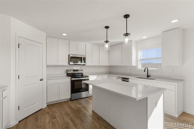 807 Colony Ridge Ct, Foristell, MO 63348 - kitchen featuring appliances with stainless steel finishes, white cabinets, light countertops, recessed lighting, and light wood finished floors