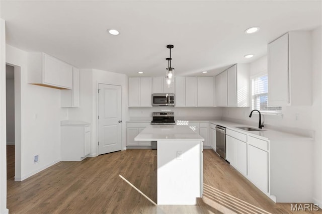 807 Colony Ridge Ct, Foristell, MO 63348 - kitchen featuring stainless steel appliances, a kitchen island, white cabinetry, light countertops, and recessed lighting