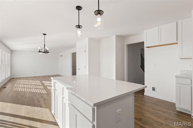 807 Colony Ridge Ct, Foristell, MO 63348 - kitchen featuring a chandelier, white cabinets, wood finished floors, a kitchen island, and hanging light fixtures