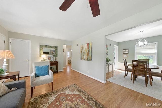 7142 Circleview Dr, Gravois Township, MO 63123 - living area featuring ceiling fan, light wood-style flooring, and a chandelier