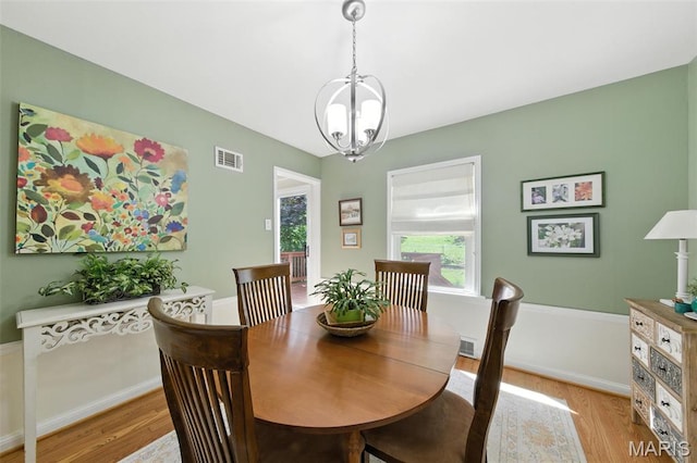 7142 Circleview Dr, Gravois Township, MO 63123 - dining room with light wood-style floors and a chandelier