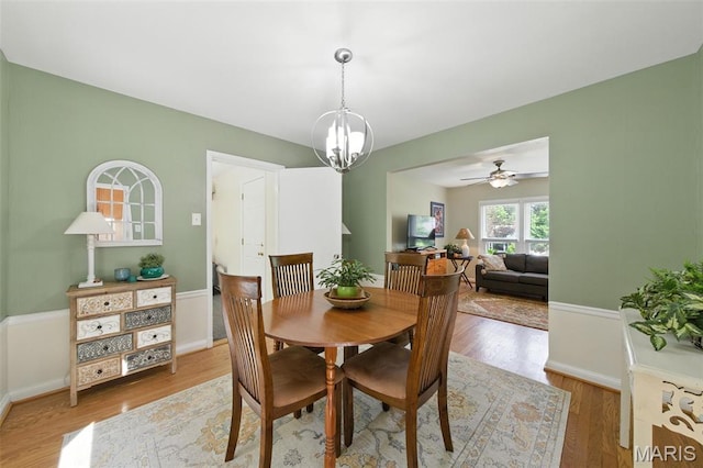 7142 Circleview Dr, Gravois Township, MO 63123 - dining area with wood finished floors, a chandelier, and ceiling fan