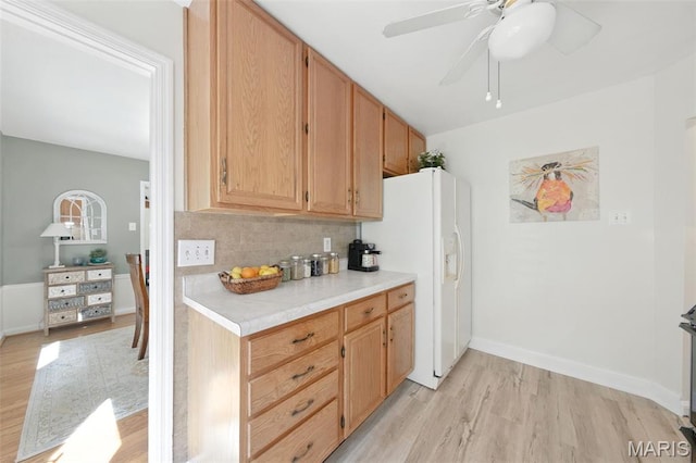 7142 Circleview Dr, Gravois Township, MO 63123 - kitchen with light wood-style floors, light countertops, decorative backsplash, white fridge with ice dispenser, and ceiling fan
