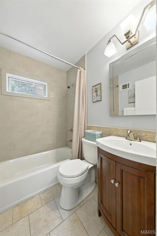 7142 Circleview Dr, Gravois Township, MO 63123 - bathroom featuring shower / bath combo, vanity, and tile patterned floors