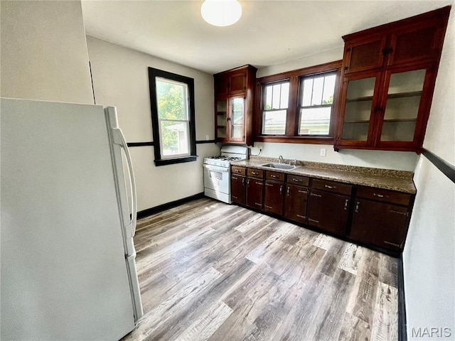 1519 Lebanon Ave, Belleville, IL 62221 - kitchen with white appliances, light wood-style floors, and glass insert cabinets