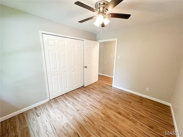 66 County Road 6680, Salem, MO 65560 - unfurnished bedroom with light wood finished floors, a closet, and a ceiling fan