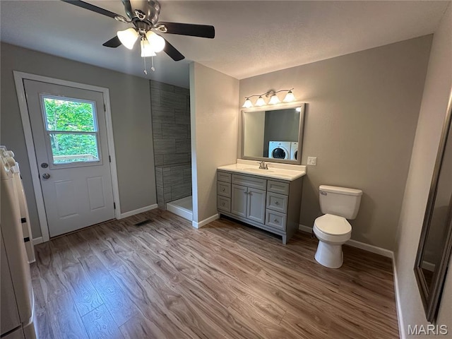 66 County Road 6680, Salem, MO 65560 - full bathroom featuring wood finished floors, vanity, tiled shower, a ceiling fan, and separate washer and dryer