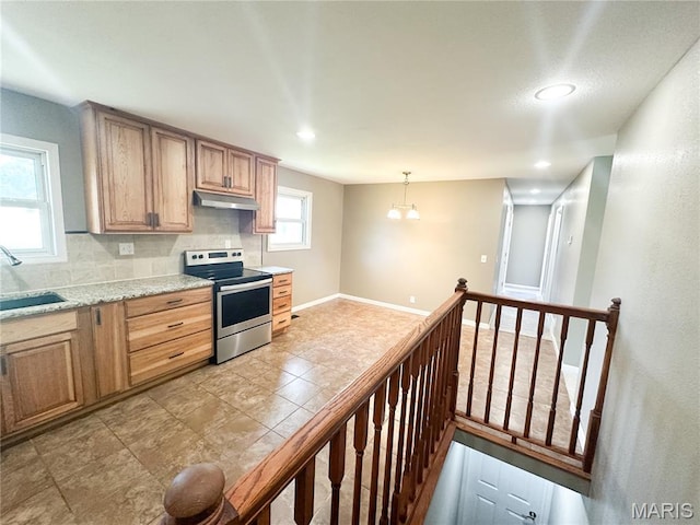 6484 County Road 3180, Salem, MO 65560 - kitchen with stainless steel electric stove, under cabinet range hood, decorative backsplash, recessed lighting, and decorative light fixtures