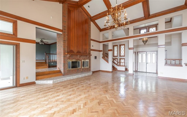 3401 Riverview Ct, Godfrey, IL 62035 - unfurnished living room with stairway, a towering ceiling, a fireplace, a chandelier, and a ceiling fan