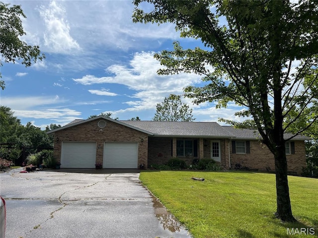 6969 US Highway 61, Jackson, MO 63755 - ranch-style home featuring brick siding, an attached garage, asphalt driveway, and a front yard