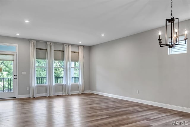 211 Cambium Ct, Wentzville, MO 63385 - empty room with a chandelier, plenty of natural light, wood finished floors, and recessed lighting
