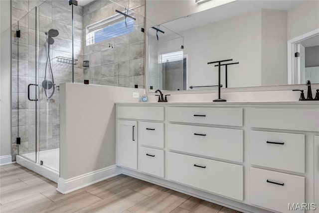 211 Cambium Ct, Wentzville, MO 63385 - bathroom with double vanity, a shower stall, and wood finished floors