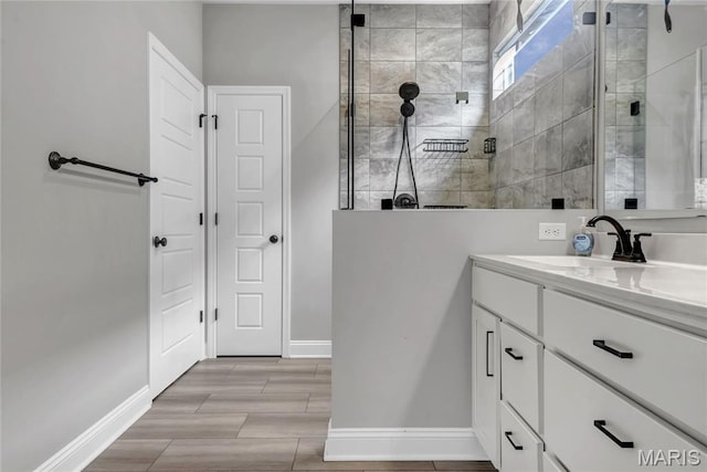 211 Cambium Ct, Wentzville, MO 63385 - bathroom featuring vanity, a tile shower, and wood finished floors