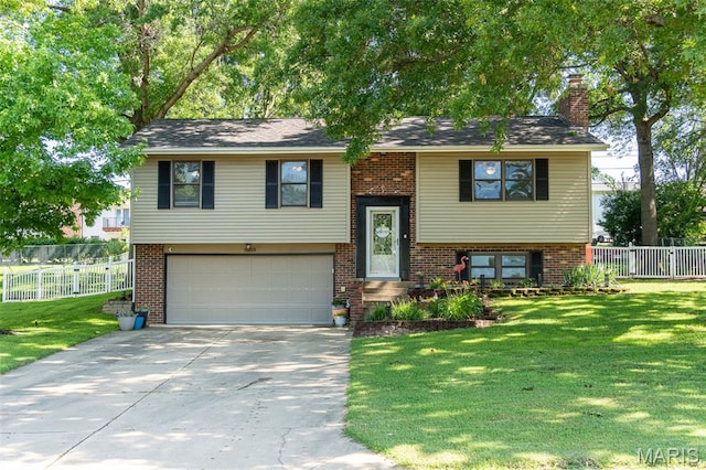 1003 Marilyn Ct, Washington, MO 63090 - bi-level home with a garage, concrete driveway, brick siding, and a chimney