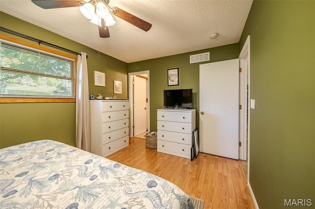 1003 Marilyn Ct, Washington, MO 63090 - bedroom featuring light wood-type flooring, a textured ceiling, and ceiling fan