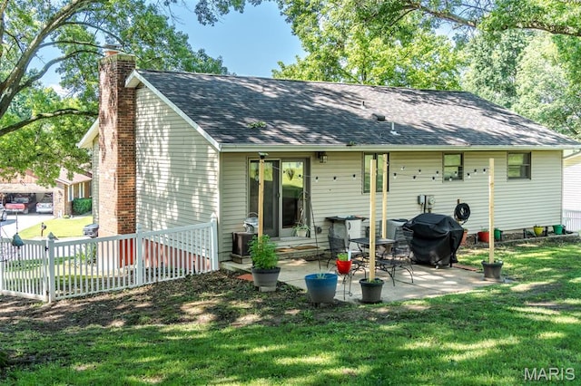 1003 Marilyn Ct, Washington, MO 63090 - back of house with a chimney, a patio area, and a shingled roof