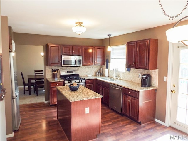 4 Green Circle Ct, Saint Peters, MO 63376 - kitchen featuring appliances with stainless steel finishes, tasteful backsplash, dark wood-style flooring, and hanging light fixtures