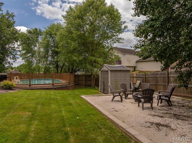 4 Green Circle Ct, Saint Peters, MO 63376 - fenced backyard with a storage unit and an outdoor fire pit