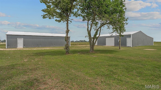 3120 State Highway F, Cardwell, MO 63829 - view of green lawn with an outbuilding and a garage