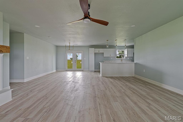 3120 State Highway F, Cardwell, MO 63829 - unfurnished living room featuring light wood finished floors, a ceiling fan, and a textured ceiling
