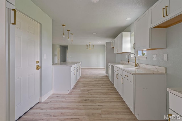 3120 State Highway F, Cardwell, MO 63829 - kitchen with white cabinetry, light wood-type flooring, pendant lighting, and recessed lighting