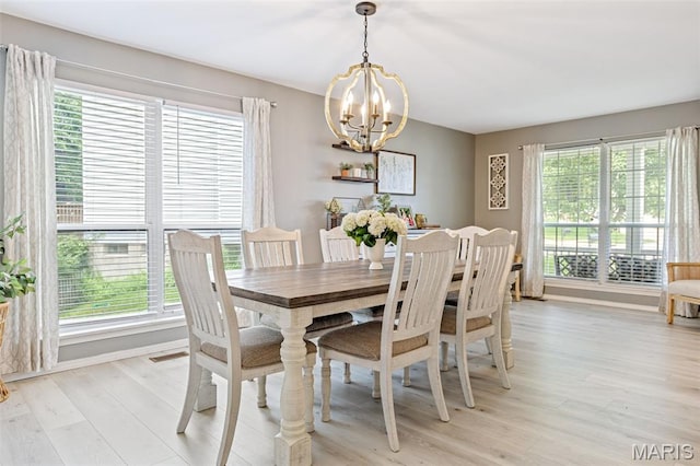404 Arbor Spring Dr, Ballwin, MO 63021 - dining space featuring a chandelier, healthy amount of natural light, and light wood finished floors