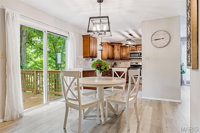 404 Arbor Spring Dr, Ballwin, MO 63021 - dining space with light wood-style floors and a chandelier