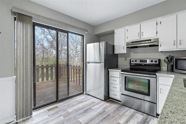 2318 Hidden Meadow Ln, Ballwin, MO 63021 - kitchen featuring appliances with stainless steel finishes, under cabinet range hood, light wood-style floors, tasteful backsplash, and a textured ceiling