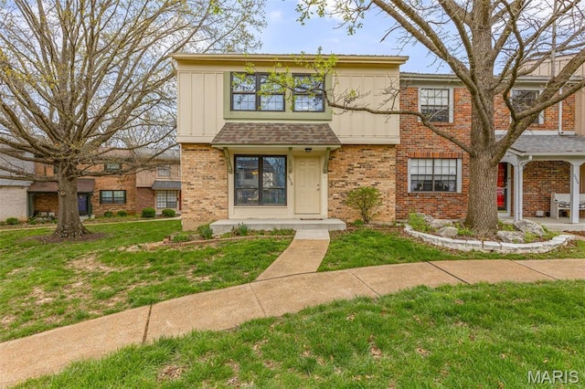 2318 Hidden Meadow Ln, Ballwin, MO 63021 - view of front of house with brick siding, a front lawn, and board and batten siding