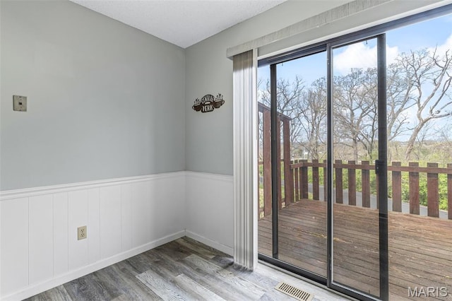 2318 Hidden Meadow Ln, Ballwin, MO 63021 - empty room featuring wood finished floors and a wainscoted wall