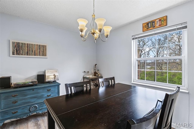 2318 Hidden Meadow Ln, Ballwin, MO 63021 - dining area with a chandelier, a textured ceiling, and dark wood-style floors