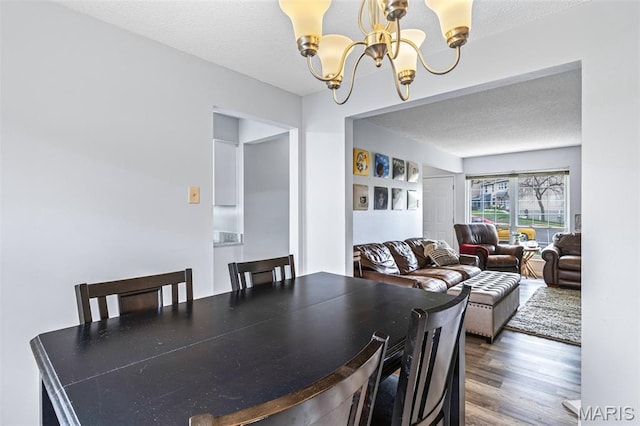 2318 Hidden Meadow Ln, Ballwin, MO 63021 - dining area featuring a chandelier, wood finished floors, and a textured ceiling