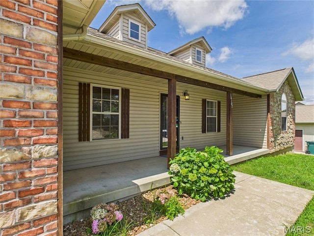 16107 Hummingbird Ln, Saint Robert, MO 65584 - view of front of house featuring covered porch, brick siding, and a shingled roof