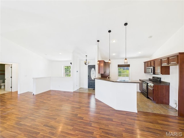 16107 Hummingbird Ln, Saint Robert, MO 65584 - kitchen with dark countertops, electric range, lofted ceiling, stainless steel microwave, and dark wood-style floors