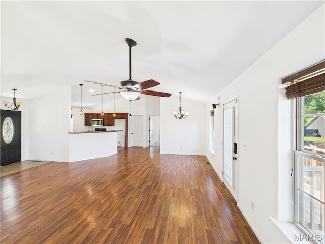 16107 Hummingbird Ln, Saint Robert, MO 65584 - unfurnished living room featuring a ceiling fan, dark wood finished floors, a chandelier, and lofted ceiling