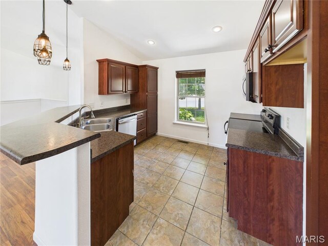 16107 Hummingbird Ln, Saint Robert, MO 65584 - kitchen featuring dark countertops, lofted ceiling, dishwasher, stainless steel microwave, and range with electric cooktop
