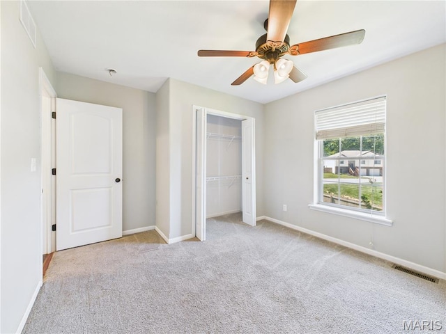 16107 Hummingbird Ln, Saint Robert, MO 65584 - unfurnished bedroom with carpet, a closet, and a ceiling fan